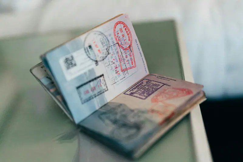 Open passport with entry and exit visa stamps